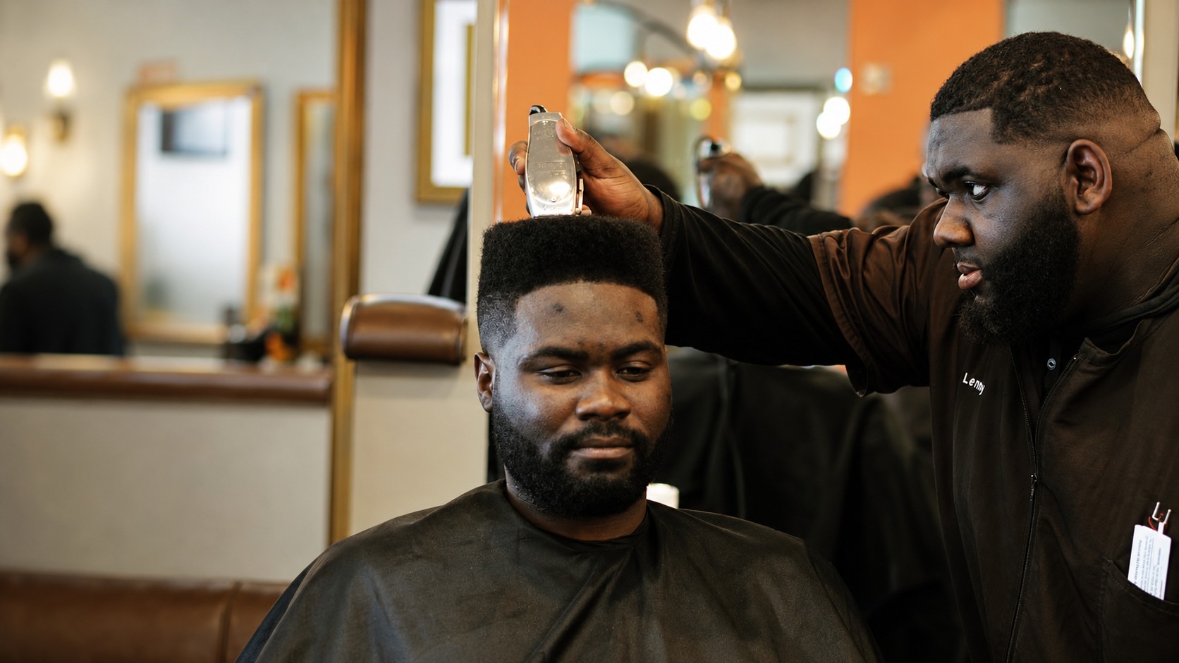 Barber carefully cutting a client's hair in a modern shop